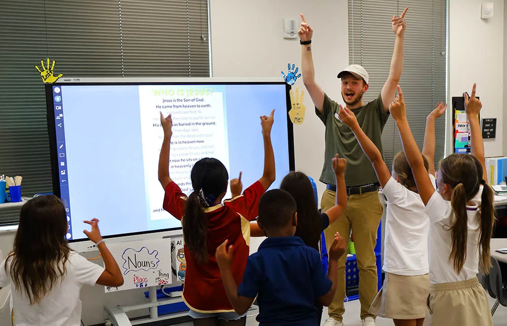 Large Group Lesson A leader teaching the large-group lesson at a Crossroads Kids Club