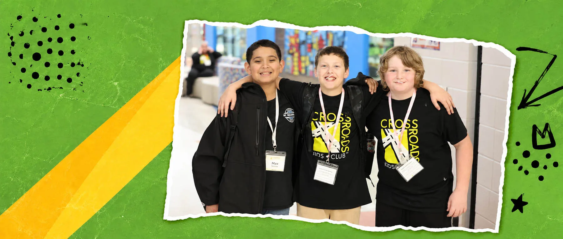 what-drives-us-bg Three boys smile with their arms around one another at Crossroads Kids Club.