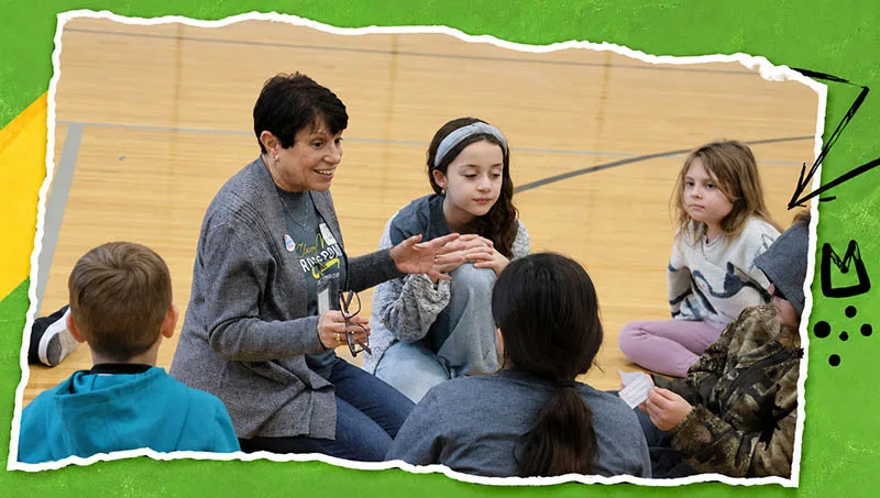 what-to-expect A volunteer working with children at a Crossroads Kids Club